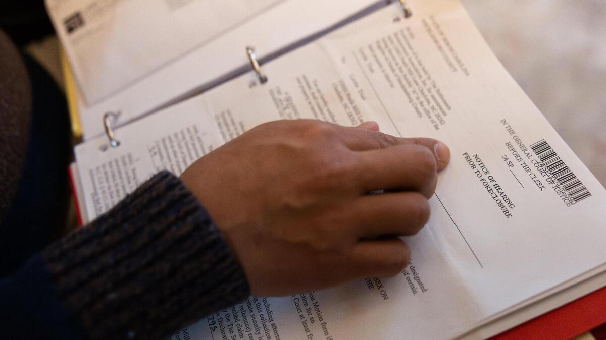 Jeffrey Baldwin points to a notice of foreclosure in his documents relating to his legal battle with his HOA in Charlotte, N.C., on Monday, January 6, 2025.