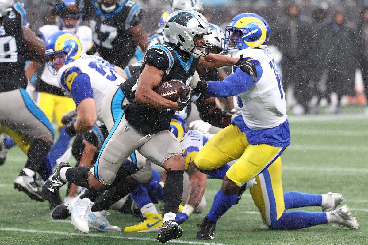 Carolina Panthers running back Chuba Hubbard, center, breaks to the outside on a run against the Los Angeles Rams defense during action on Nov. 30, 2025, at Bank of America Stadium in Charlotte. The Panthers defeated the Rams 31-28.