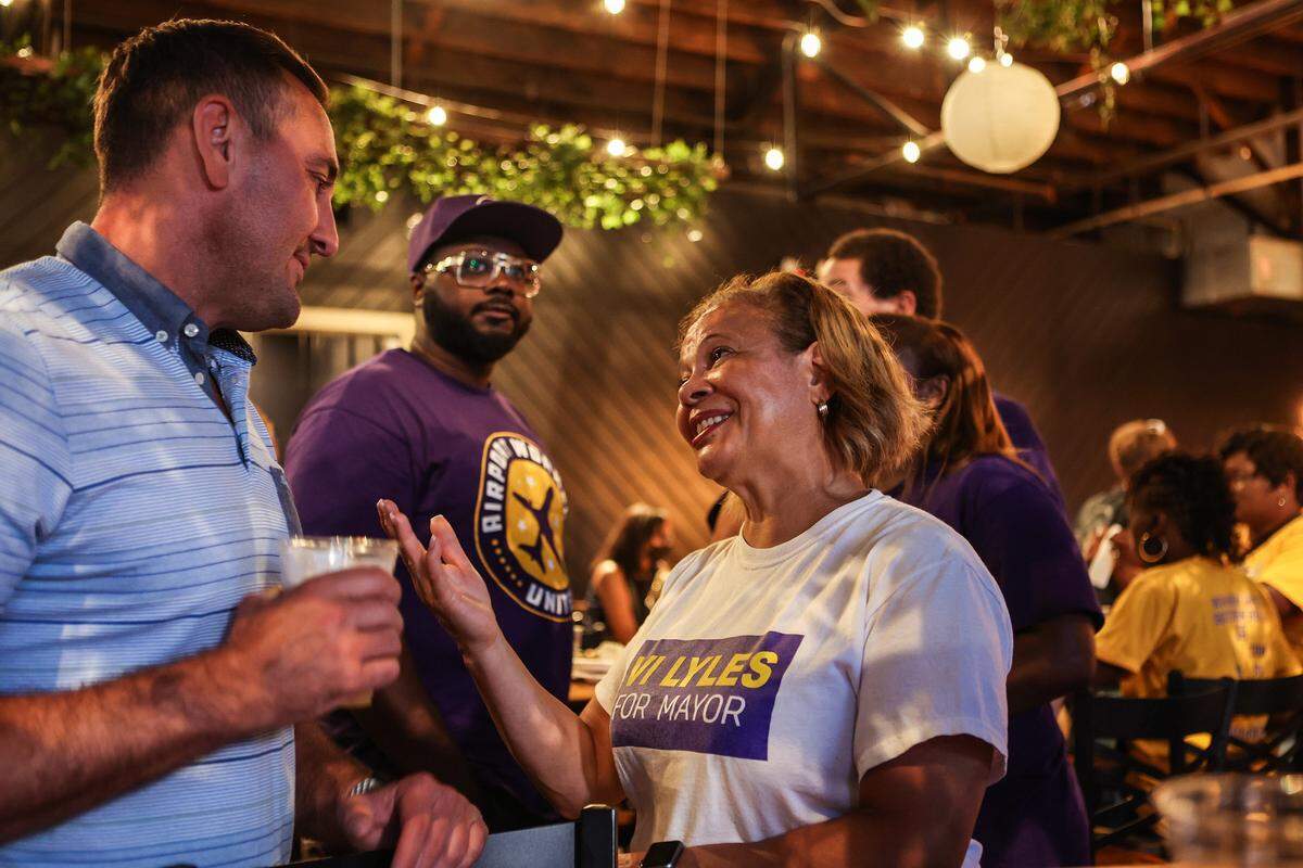 At-large Mayor Vi Lyles, left, speaks with a supporter a post-election watch party at Heist Brewery on Tuesday, July 26, 2022 in Charlotte, NC. 