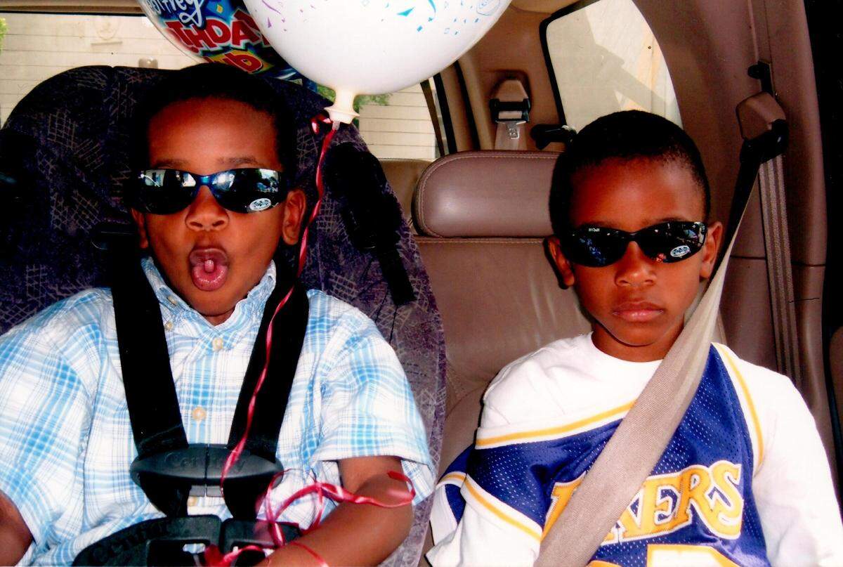 Chase, left, and his brother, Nic, pose for a picture with sunglasses on as kids. The two were always close and connected by basketball.