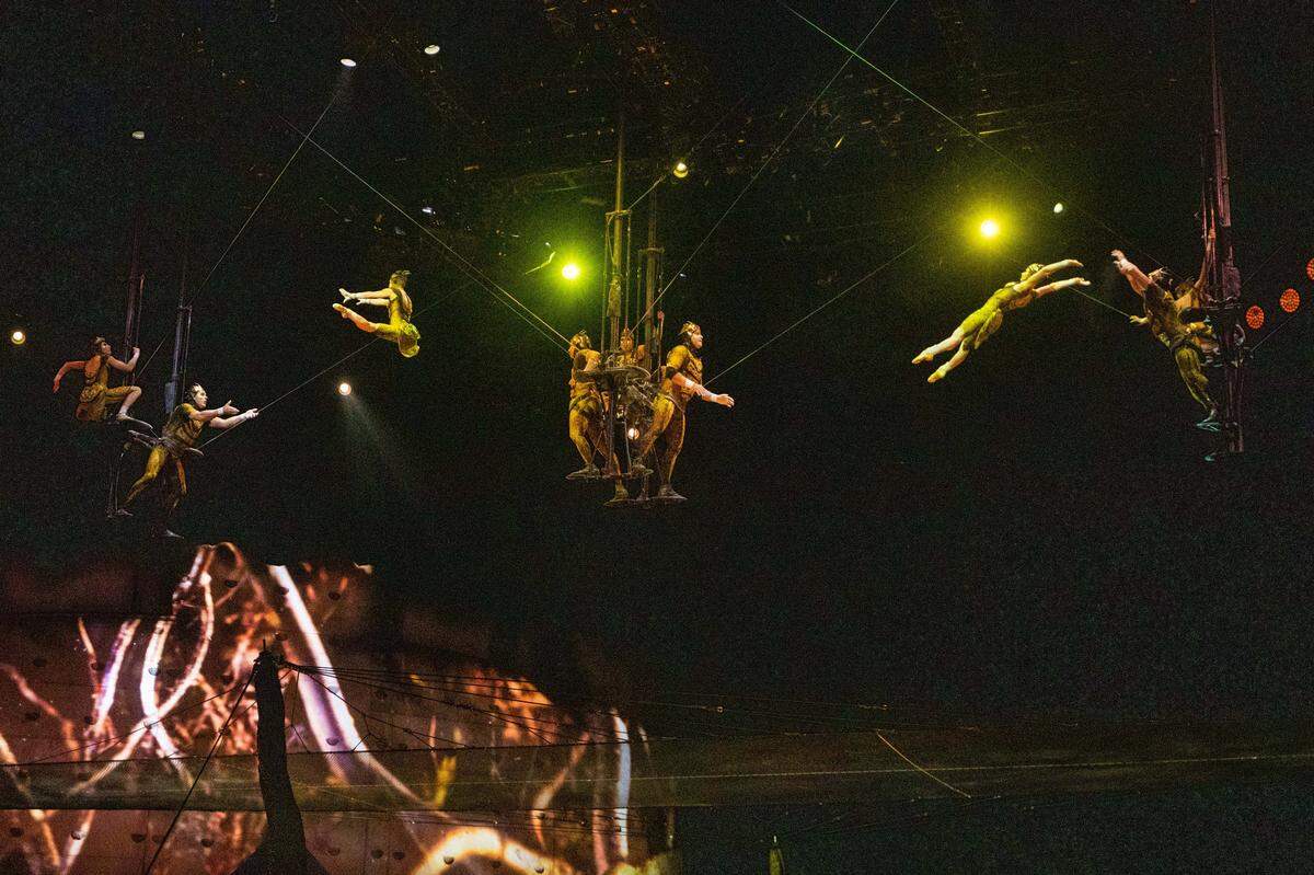 Performers fly above the stage during Cirque du Soleil’s “OVO.”