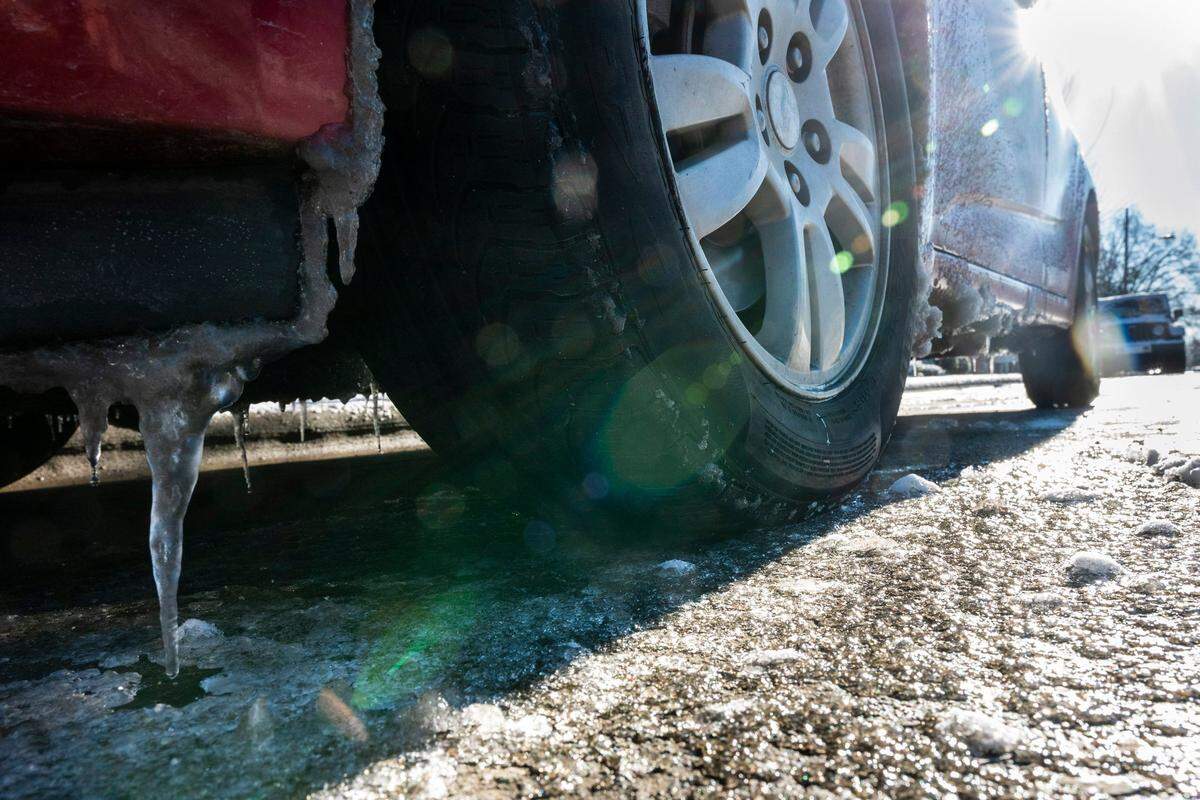 A parked car sits on an icy road on 36th Street Saturday, January 22, 2022 in Charlotte, NC.