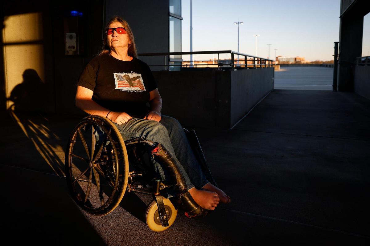 Barbara Ryan sits in the uptown parking deck where she slept in February 2019. Ryan, who is paralyzed from the waist down and legally blind, lost her longtime home for back taxes that she’d actually paid.