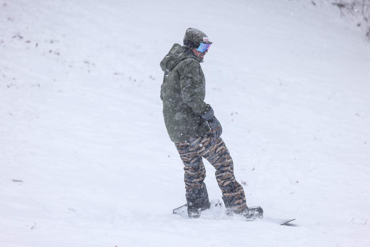 A man snowboards in Cordelia Park in Charlotte, N.C., on Saturday, January 31, 2026.