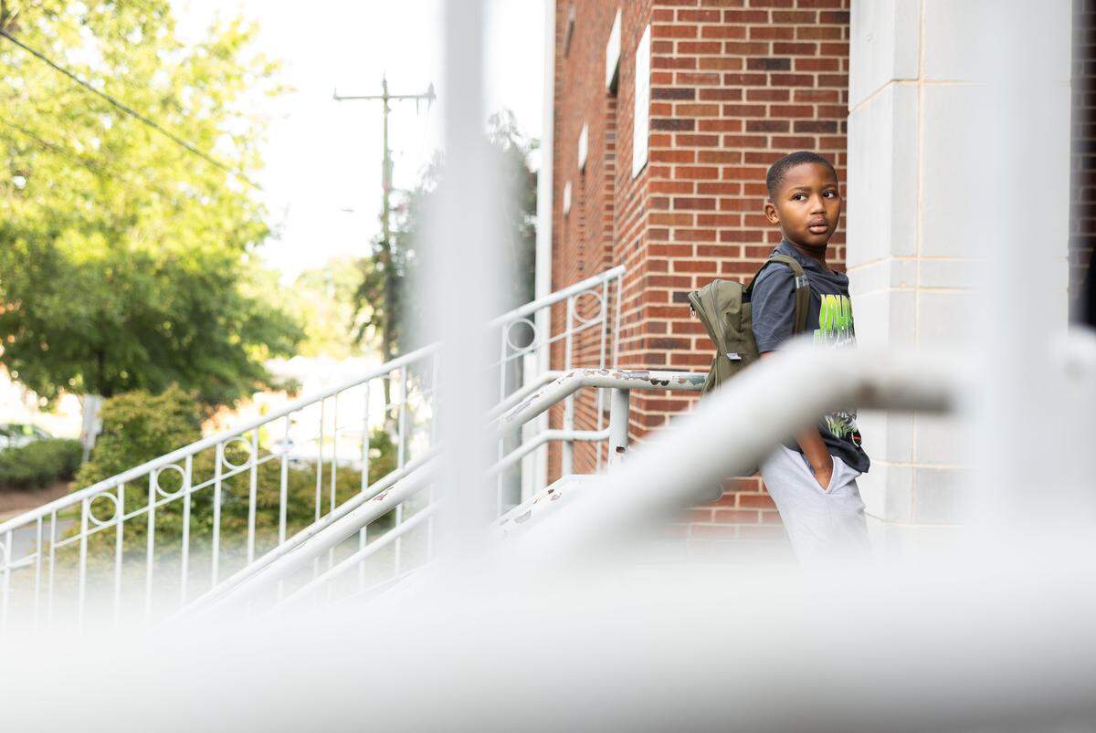 A student waits for the bell before first day of school at Elizabeth Traditional School in Charlotte, N.C., on Monday, August 25, 2025.
