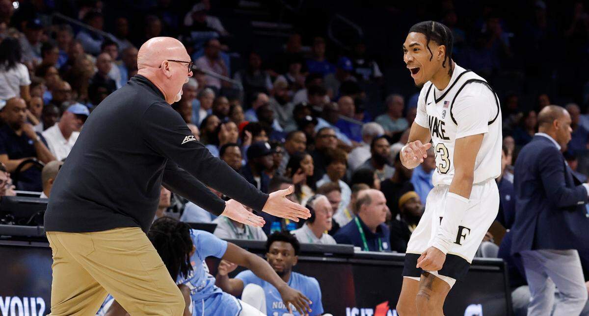 Wake Forest head coach Steve Forbes celebrates with Hunter Sallis (23) during the first half of UNC’s game against Wake Forest in the quarterfinals of the 2025 ACC Men’s Basketball Tournament at the Spectrum Center in Charlotte, N.C., Thursday, March 13, 2025.