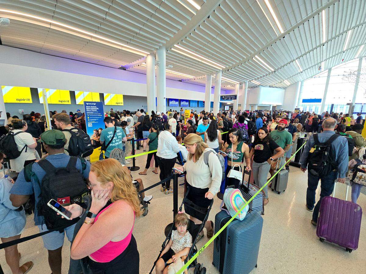 Passengers wait in line at Charlotte Douglas International Airport, one of the busiest facilities in the world.
