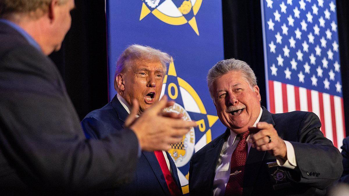 Former President Donald Trump gives remarks to the Fraternal Order of Police in Charlotte, N.C., on Friday, September 6, 2024. on the right is Jimmy Holderfield, Natinal Secretary of the Fraternal Order of Police.