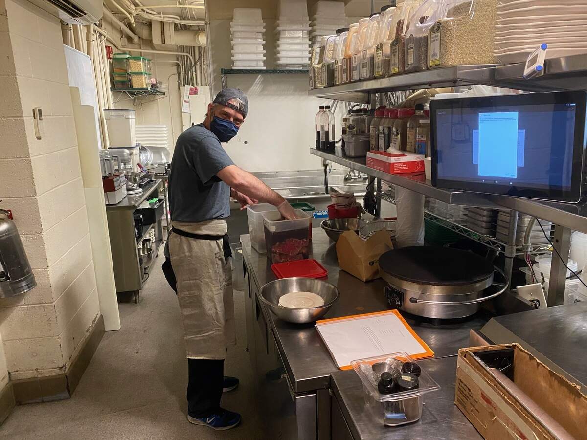 Chef Steve Kuney cooks in the kitchen at Crepe Cellar. All of the restaurant employees are now wearing masks. Kuney was preparing for the large order with Feed the Front Lines on Wednesday, April 15, 2020. The delivery was being prepared for a Novant hospital.