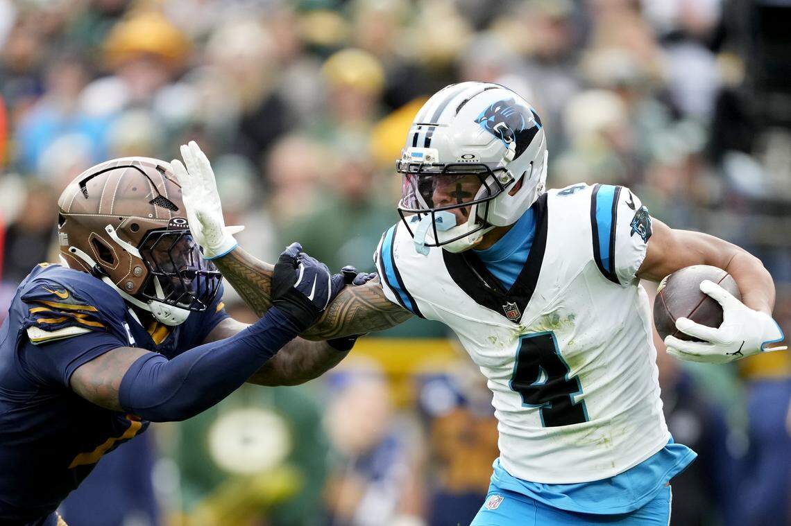 Carolina’s Tetairoa McMillan tries to elude Green Bay’s Quay Walker during the third quarter of Sunday’s game at Lambeau Field.