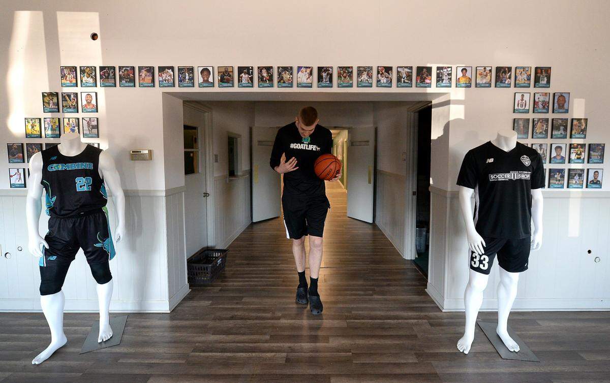 Patrick Wessler ducks his head as he walks through a doorway at Combine Academy in Lincolnton, NC on Monday, February 14, 2022. Wessler is the center for the Combine Academy Goats basketball team, he is 7-foot tall. Wessler will be attending Virginia Tech.