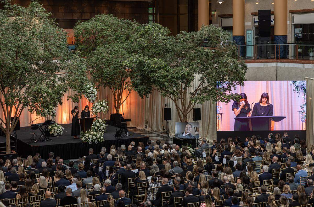 LendingTree CEO Doug Lebda's daughters, Rachel, left, and Abby speak during his memorial service at Founders Hall in Charlotte, N.C., on Sunday, October 19, 2025.