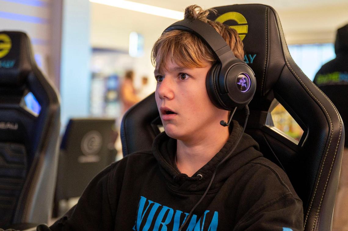 Traveler Callen McCoy reacts to his screen while playing Minecraft in the Gameway lounge in Concourse E of the Charlotte Douglas International Airport. McCoy spent his layover between flights from Pittsburgh and to Johnson City in the lounge playing Minecraft and chatting to his friends online.