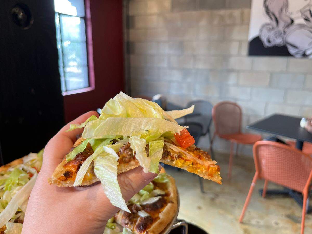 Zepeddie’s bacon cheeseburger pizza comes topped with lettuce, pickles and tomato.