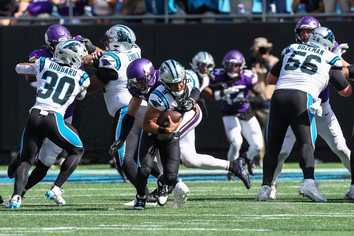 Panthers quarterback Bryce Young, center, is sacked by Minnesota safety Harrison Smith during the game at Bank of America Stadium on Sunday, October 1, 2023 in Charlotte, NC.