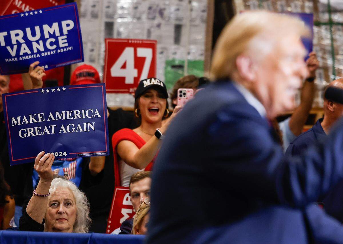 Supporters cheer for Former President Donald Trump as he delivers remarks at a campaign rally inside the Mosack Group manufacturing warehouse in Mint Hill, NC on Wednesday, September 25, 2024.