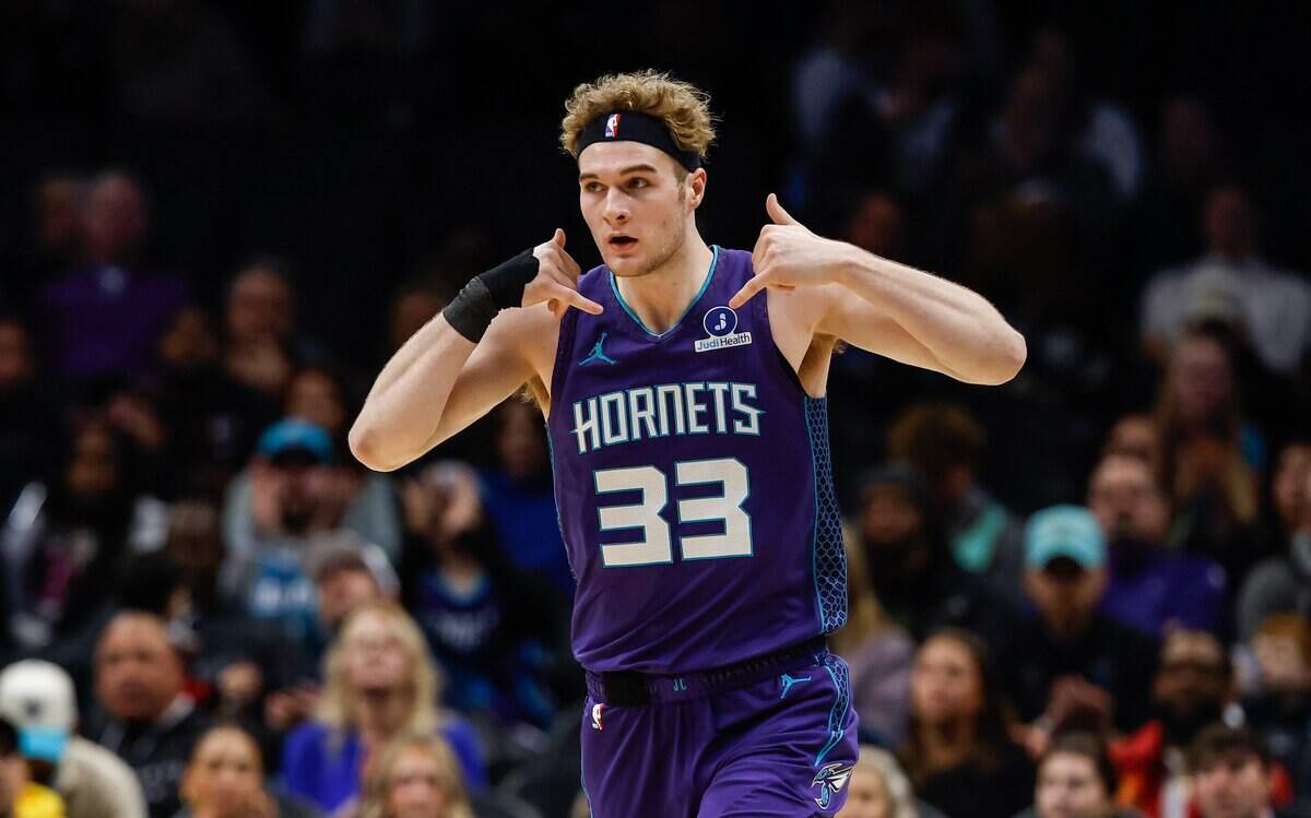Hornets forward Liam McNeeley holds up his hands like two telephones after making a 3-point shot during the game against the Bucks at Spectrum Center in Charlotte, NC on Wednesday, Nov 12, 2025.