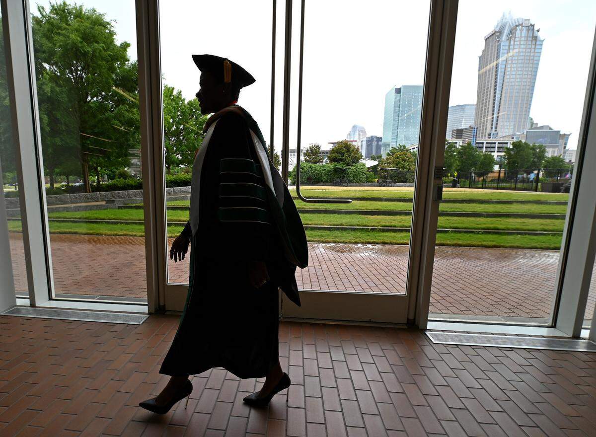 LaShana Wiggs, a UNC Charlotte graduate on Friday, May 13, 2022. In January 2019, LaShana Wiggs’ life was altered. Wiggs, a wife, mother of three, doctoral student and executive at one of Charlotte’s largest employers, suddenly lost vision in her right eye. Visits to multiple doctors and specialists, a battery of tests, a three-day stay in the ER and a misdiagnosis eventually led to a conclusive answer for her issues. Wiggs was diagnosed with multiple sclerosis. Wiggs is graduated on Friday, May 13, 2022 with a doctorate and is the commencement speaker.
