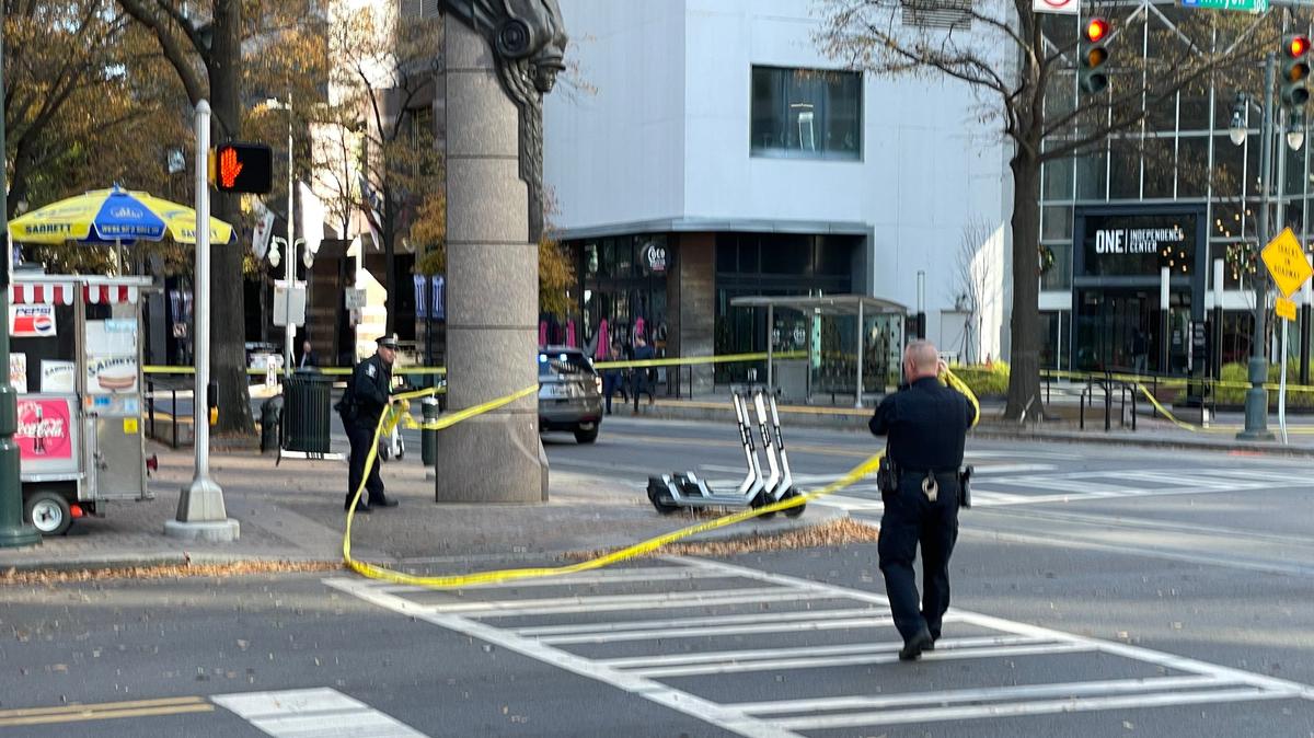 Charlotte-Mecklenburg police officers clear the scene of a shooting at Trade and Tryon streets in uptown Charlotte, NC, on Tuesday, Dec. 7, 2021. A suspect was arrested after a foot chase, police said.