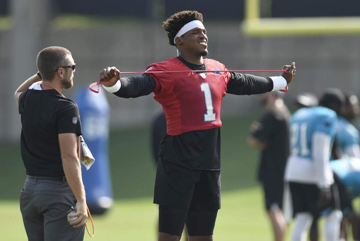 Carolina Panthers quarterback Cam Newton (1) stretches during practice at the team’s practice facility on Wednesday. Newton says attention to detail is the difference between being a football player and a professional football player.