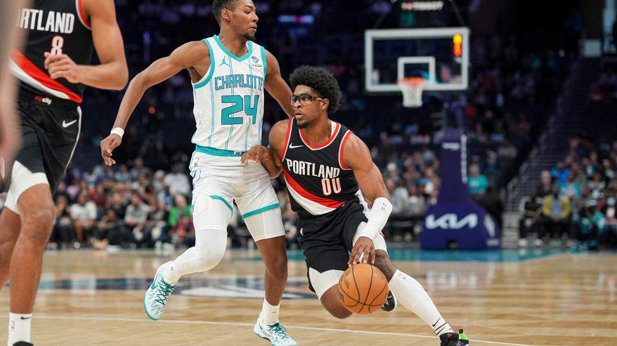 Apr 3, 2024; Charlotte, North Carolina, USA; Portland Trail Blazers guard Scoot Henderson (00) drives to the basket against Charlotte Hornets forward Brandon Miller (24) during the first quarter at Spectrum Center.