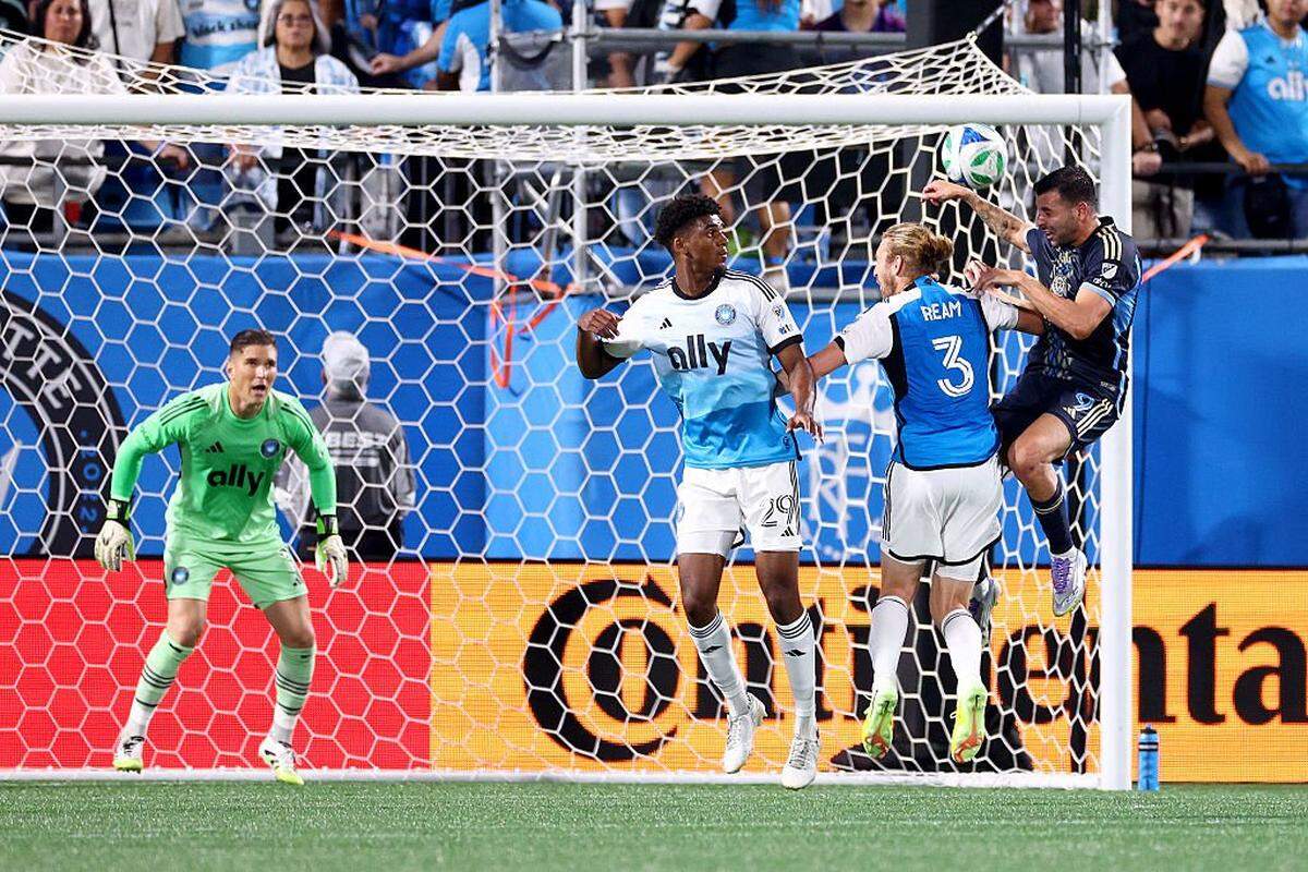 Adilson Malanda (29) and Tim Ream (3) of Charlotte FC defend a header by Tai Baribo (9) of Philadelphia Union during the second half of the MLS match between Philadelphia Union and Charlotte FC at Bank of America Stadium on October 18, 2025 in Charlotte, North Carolina.