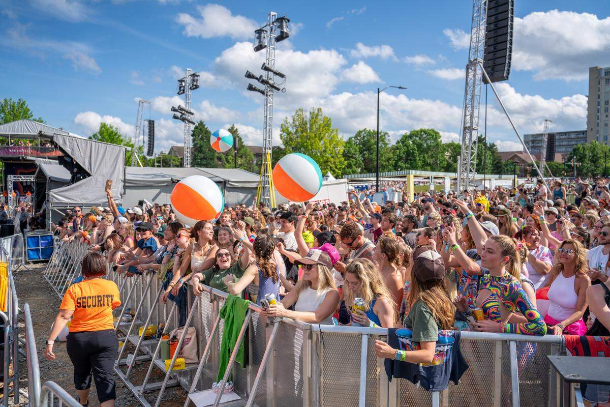 Fans at Lovin’ Life Music Fest bounce around beach balls between sets.