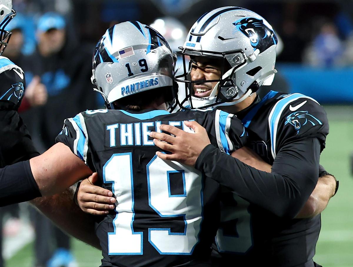 Carolina Panthers wide receiver Adam Thielen, left, is congratulated by quarterback Bryce Young after Thielen caught a touchdown pass during action against the Tampa Bay Buccaneers at Bank of America Stadium in Charlotte, NC on Sunday, December 1, 2024. The Buccaneers would defeat the Panthers in overtime 26-23.