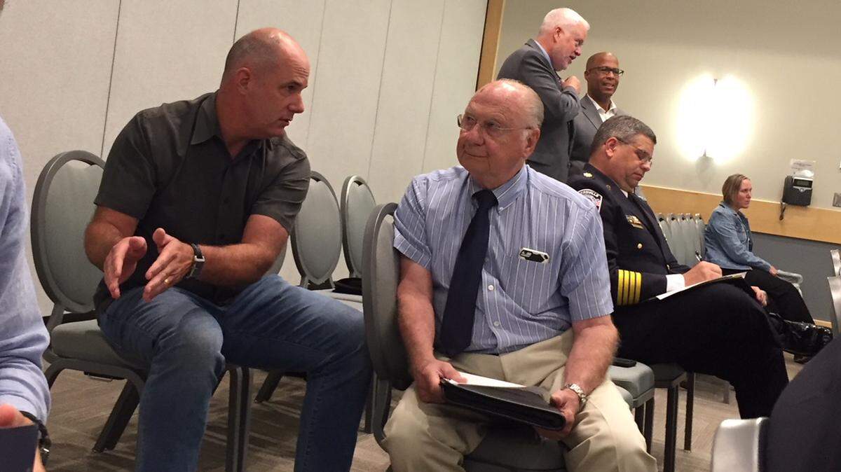 Charlotte-Mecklenburg school board member Sean Strain (left) talks to Matthews Town Commissioner Kress Query before Thursday’s meeting of the House Select Committee on School Safety, held in Charlotte.