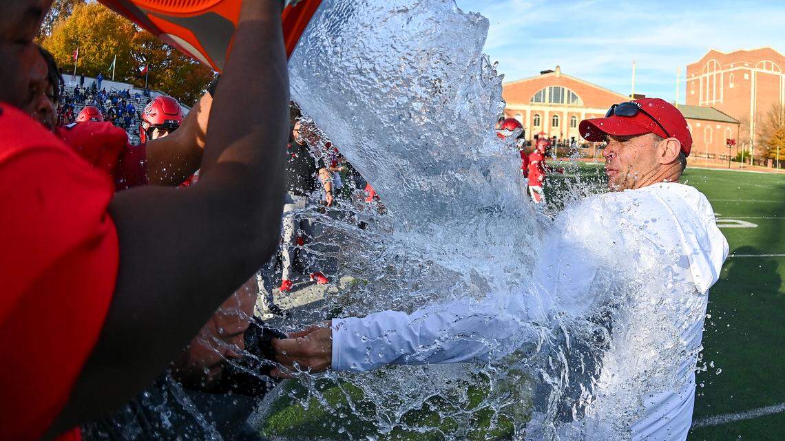 Davidson football players pour water on coach Scott Abell after the Wildcats won their second straight Pioneer Football League title Saturday in their win over Drake.