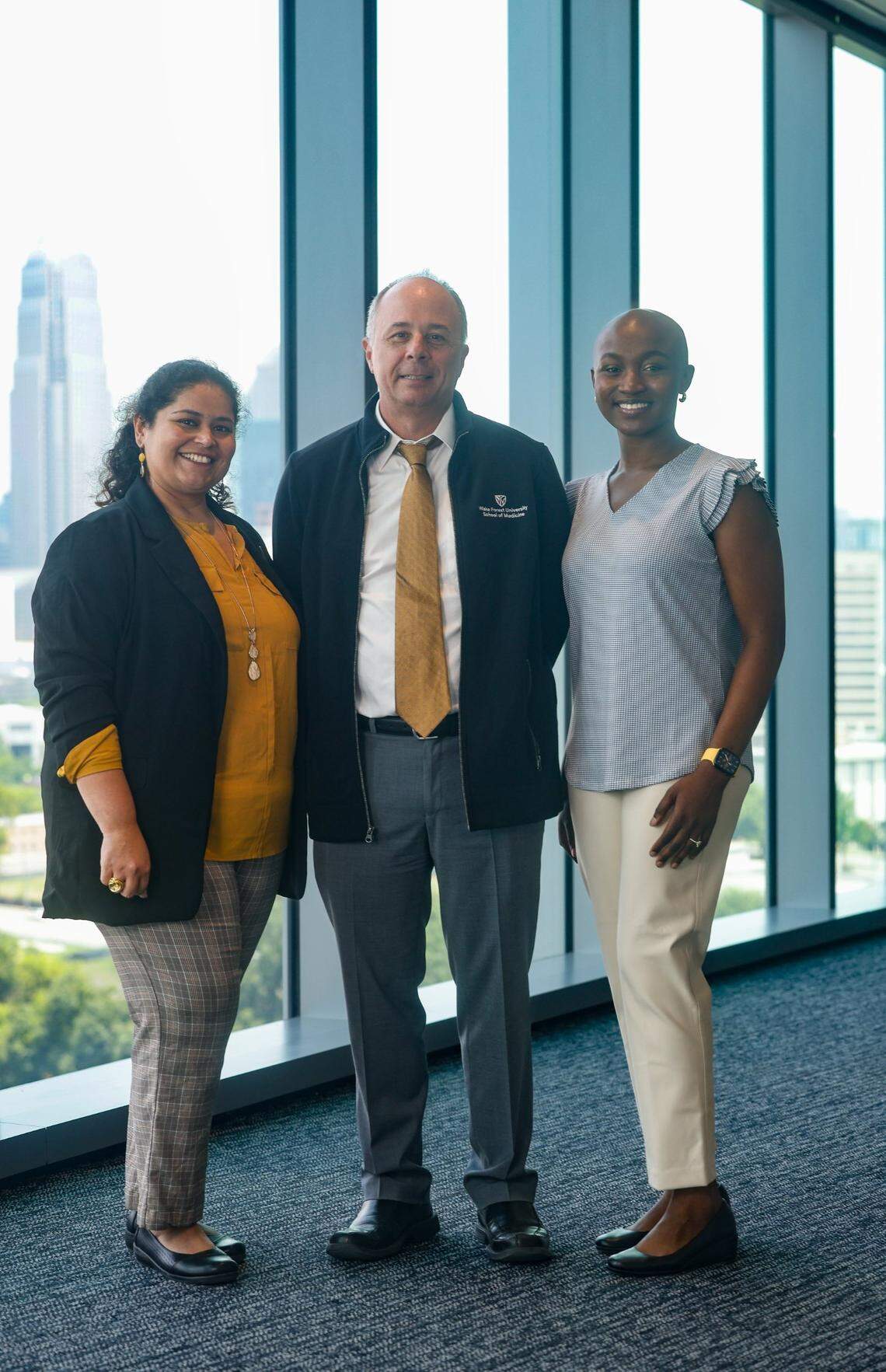 Dr. Deeksha Sikri, left, Dr. Chris Burns, center, and medical student Adunoluwa Akinola inside the new Wake Forest University School of Medicine - Charlotte. “Eevery milestone feels like we are etching footprints and handprints in fresh concrete,” Sikri said.