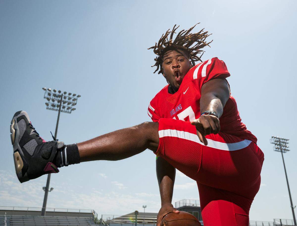\Olympic High School Trojans’ Football No. 77 center, 17-year old Jeremiah Burch Jr., poses for portraits at the Olympic High football field as the Charlotte Observer boy’s athlete of the year, June 15, 2022. “I’ve been playing football since I was five years old,” Burch says. “All of my uncles played it, my dad played it, and my grandpa played it, so I grew up around football my whole life,” he said. In 2021, Burch had the opportunity to play in the Shrine Bowl and won several awards for football and several more as a track and field athlete throwing shot-put and discus.