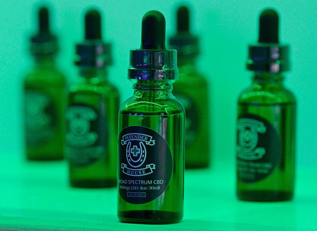 A row of Lavender House-branded CBD oil lines a shelf at the Charlotte dispensary.