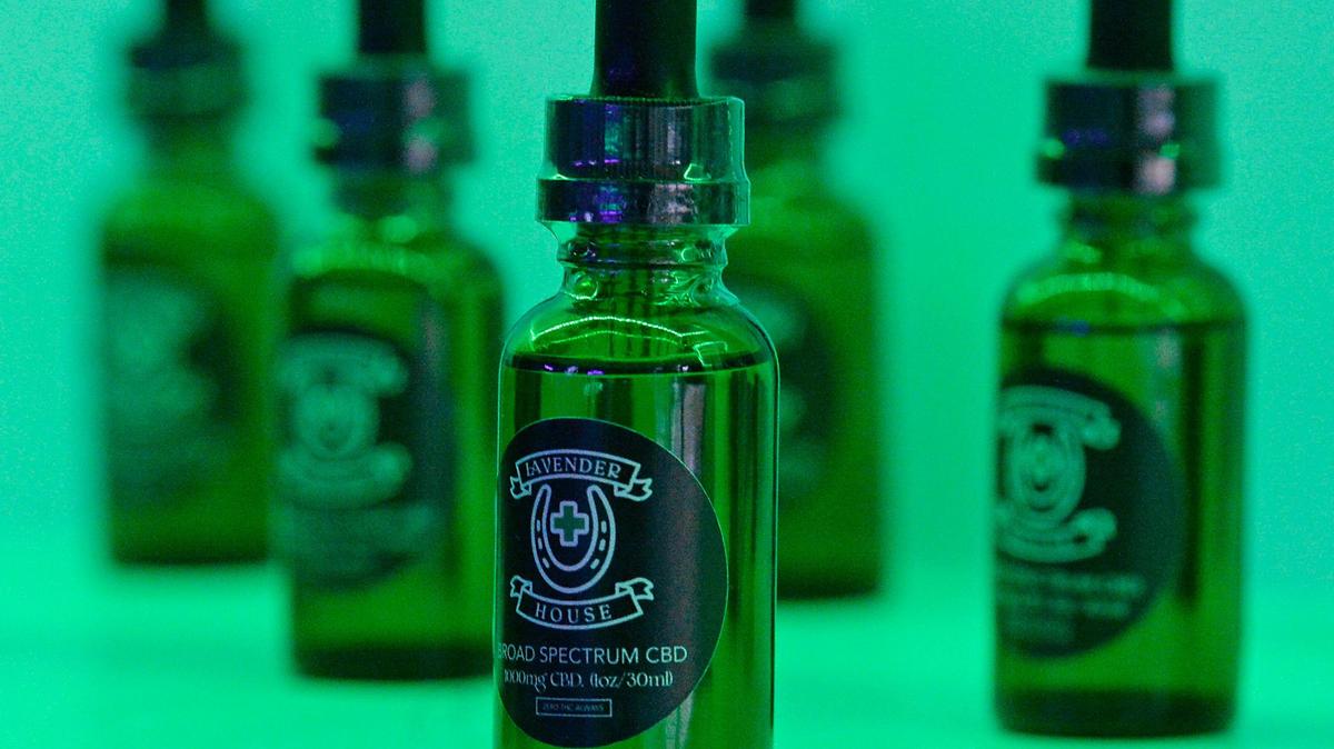 A row of Lavender House-branded CBD oil lines a shelf at the Charlotte dispensary.