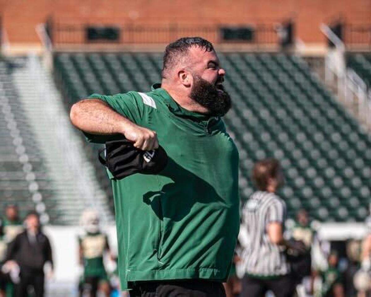 Charlotte football defensive coordinator Ryan Osborn gives direction to his players during practice.