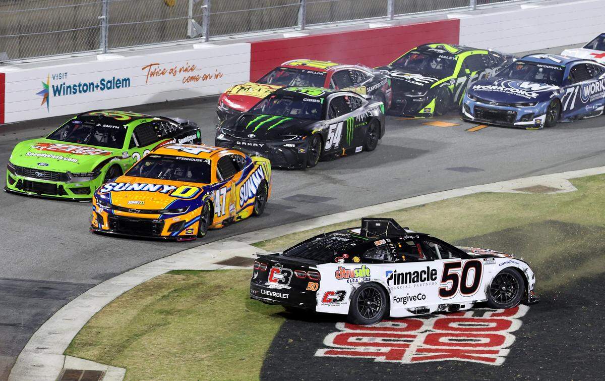 Driver Burt Myers goes into the grass area of Turn 1 as a portion of the NASCAR Cup Series Last Chance Race field passes by at Bowman Gray Stadium in Winston-Salem, NC on Sunday, February 2, 2025. Driver Kyle Larson won the race.