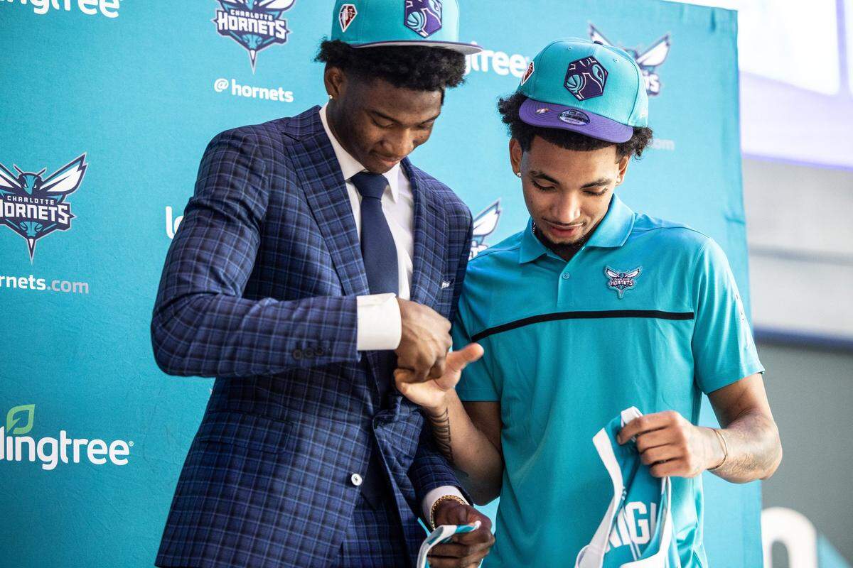 Charlotte Hornet’s draft picks, Kai Jones, left, and James Bouknight, shake hands during a press conference at the Spectrum Center in Charlotte, N.C., on Friday, July 30, 2021.