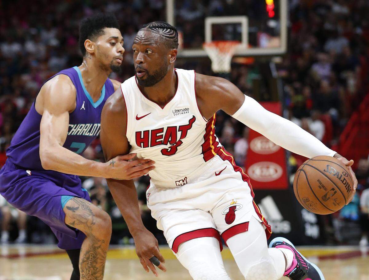 Heat guard Dwyane Wade, right, drives past Charlotte Hornets guard Jeremy Lamb during the second half Sunday, March 17, 2019, in Miami.