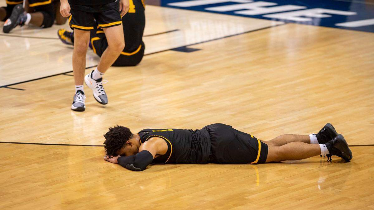 Appalachian State guard Justin Forrest (1) lies on the floor after his team’s loss to Norfolk State in a First Four game in the NCAA men’s college basketball tournament, Thursday, March 18, 2021, in Bloomington, Ind.