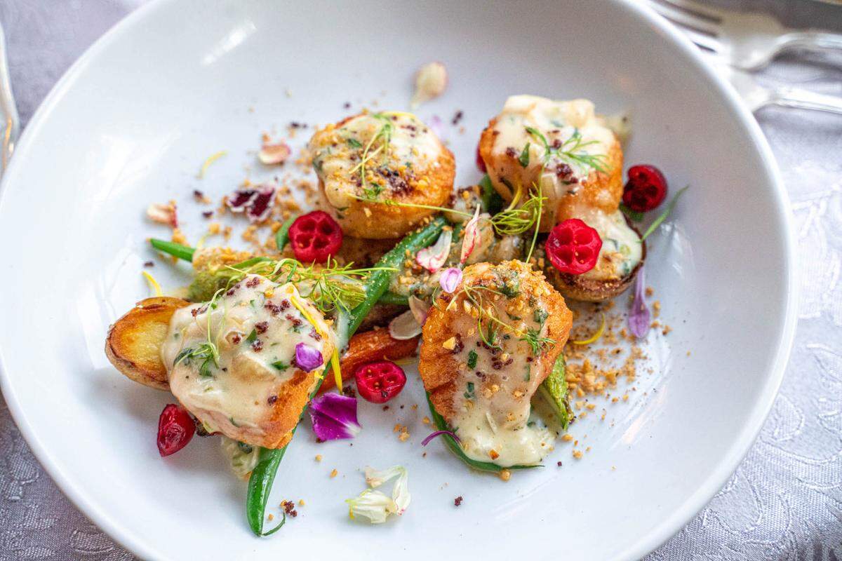 McNinch House’s Pan Seared Scallops with smoked-herb butter, picked cranberries and toasted hazelnuts.