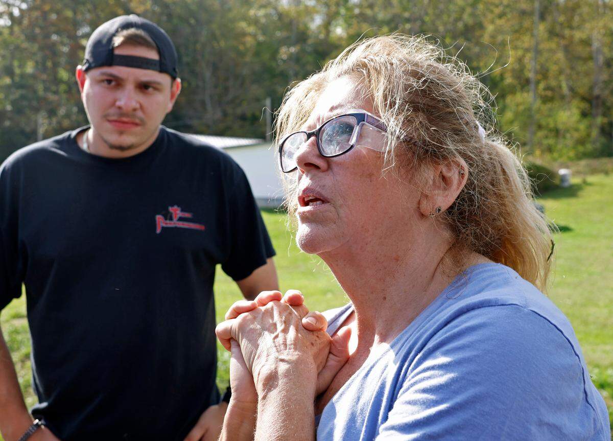 Loretta Zahn of Poplar, N.C., and Jett Murphy, left, were among members of the community waiting for Bravo Company 1-171 to deliver bottled water and ready to eat meals in Western North Carolina on Thursday, Oct. 3, 2024. Zahn and her community are suffering the effects of damage from Hurricane Helene.