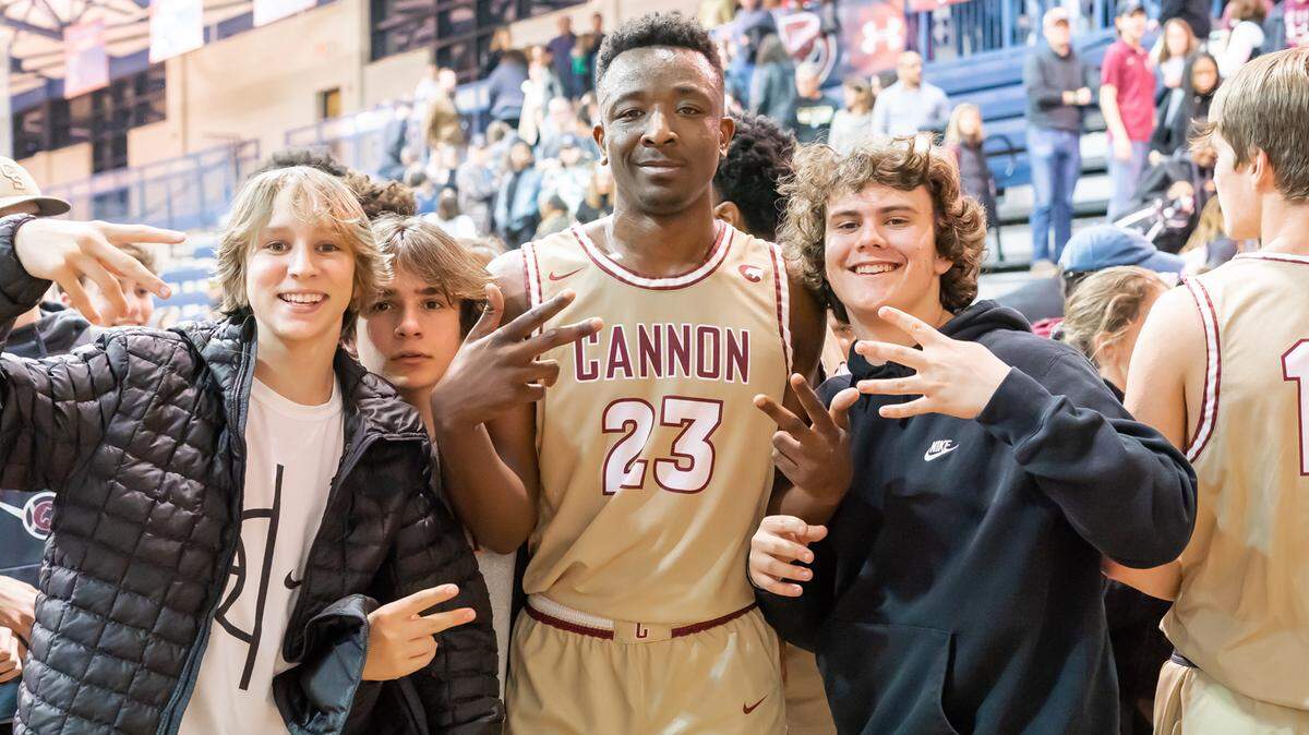 Cannon’s D.J. Nix celebrates with a few fans after the Cougars defeated Greensboro Day to advance to the state final.