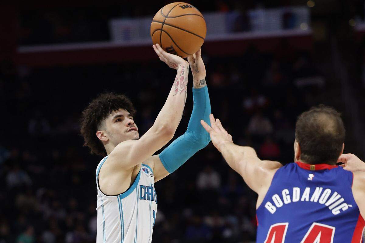 Charlotte Hornets guard LaMelo Ball (1) shoots on Detroit Pistons forward Bojan Bogdanovic (44) in the second half at Little Caesars Arena.
