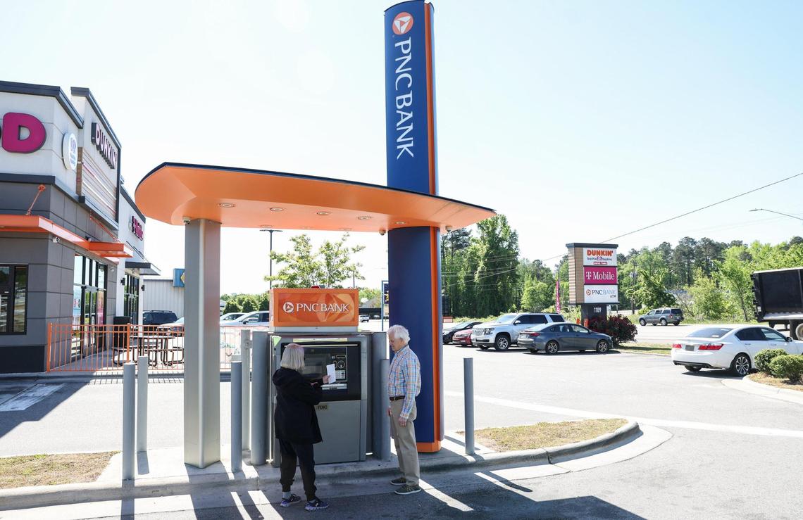 Carol Gibson, left, and her husband Carl Gibson deposit business checks at a PNC Bank ATM off of Highway 74 in Wadesboro, southeast of Charlotte. Along with the inconvenience of driving to another town outside of Anson County, they said there are safety concerns. “With a PNC (branch) here, it was very easy. I could go every day if I needed to,” Carol said. “Since the bank left we’ve got the ATM.”