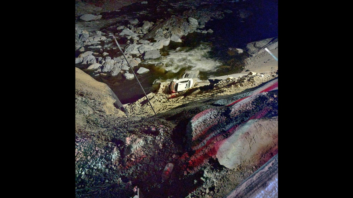 The crash happened around 9 p.m. Saturday, Nov. 9, near the Tennessee state line, and photos shared by the Junaluska Fire Department show the vehicle was left teetering over rapids in the Pigeon River.