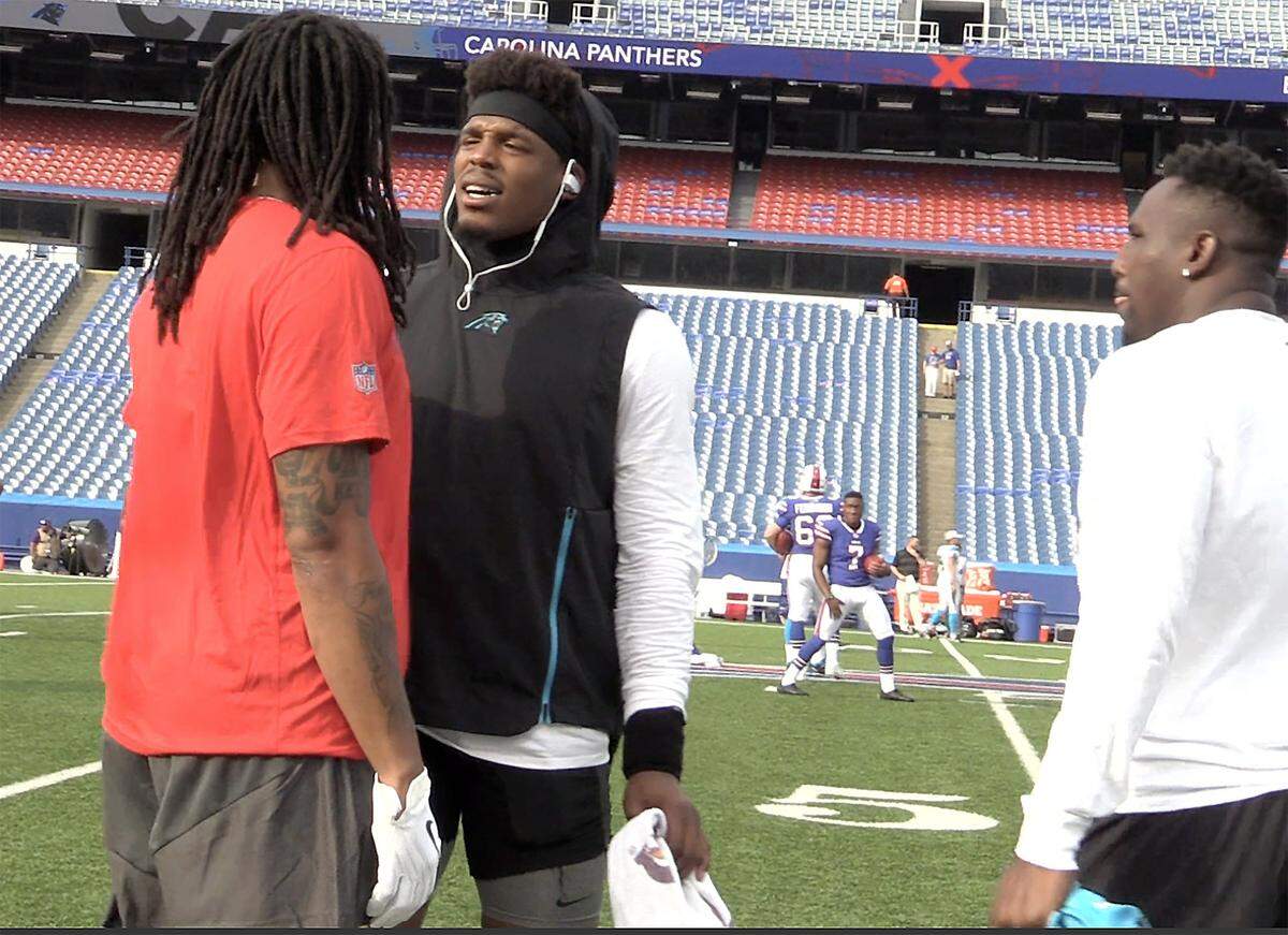 Buffalo Bills wide receiver Kelvin Benjamin, left, is spoken to by Carolina Panthers quarterback Cam Newton, right, as  linebacker Thomas Davis, right, looks on during a warmup period for the teams at New Era Field in Orchard Park, NY on Thursday, August 9, 2018. Benjamin made uncomplimentary statements about Newton and his time in Carolina last week. The team’s play an exhibition Thursday night.