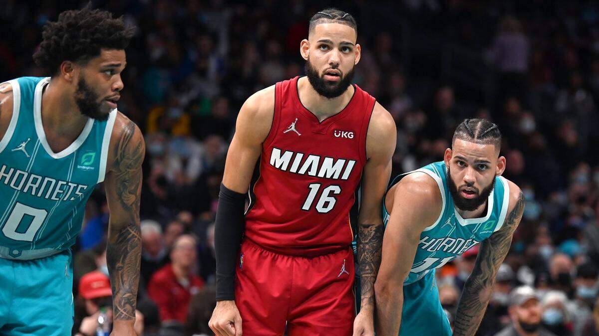 Miami Heat forward Caleb Martin, center, lines up next to his brother Charlotte Hornets forward Cody Martin, right, along the lane during second half action at Spectrum Center on Saturday, February 5, 2022 in Charlotte, NC. The Heat defeated the Hornets 104-86.