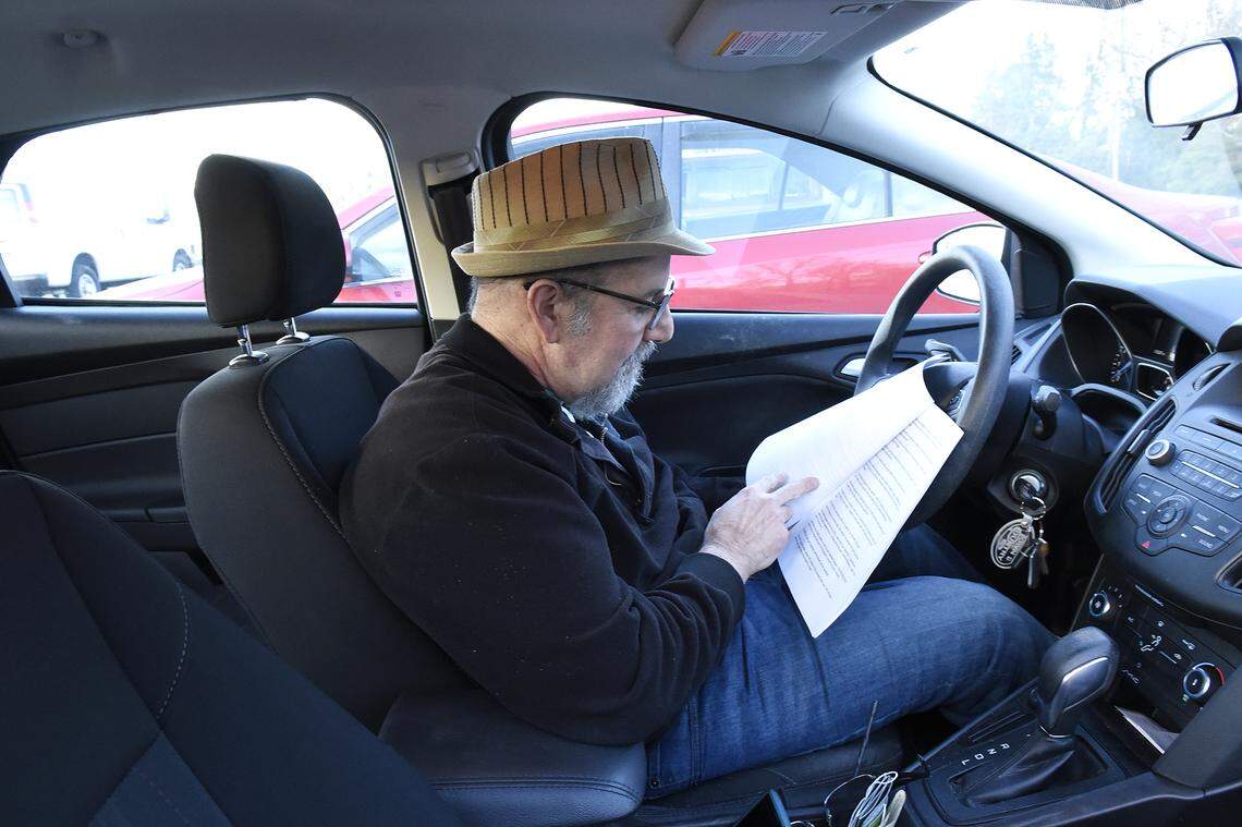 57-year-old Glenn Lurie in his car going over his jokes before a performance.