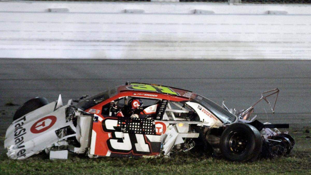 Myatt Snider (31) sits in his car after crashing during the final lap of a NASCAR Xfinity Series auto race Saturday, Feb. 19, 2022, at Daytona International Speedway in Daytona Beach, Fla. (AP Photo/Chuck McQuinn)