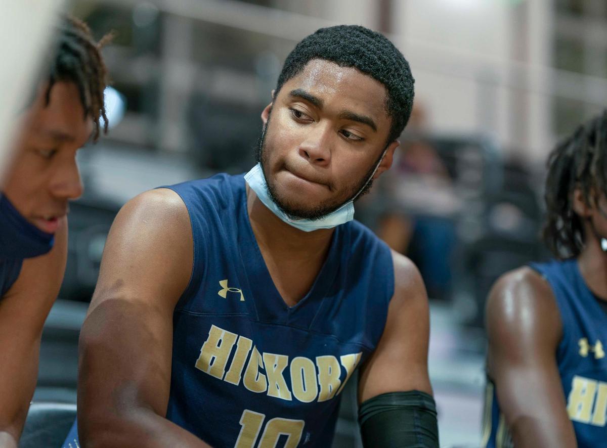 Hickory Grove’s Jasiah Wilson (center) sits for a timeout during late 1st half action at the Phenom Holiday Classic Wednesday December 23, 2020.